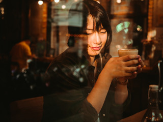 Asian woman drinking coffee in  coffee shop cafe