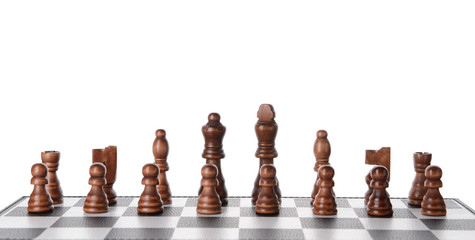Chess pieces on game board against white background