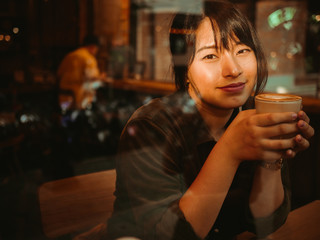 Asian woman drinking coffee in  coffee shop cafe
