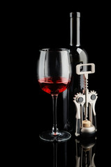 Fototapeta na wymiar Bottle and glass of red wine with corkscrew on dark background