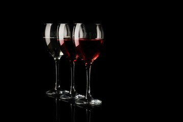 Glasses of red wine on dark background