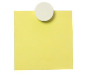 Yellow adhesive note and white magnet button on whiteboard.