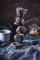 Concept flying muffin carrot-chocolate dusted with icing sugar. On a dark background