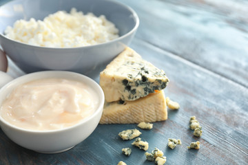 Different milk products on color wooden table