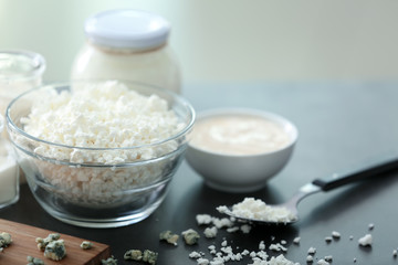 Bowl with cottage cheese on dark table