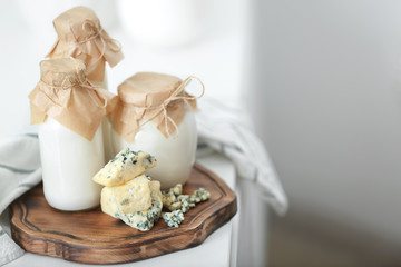 Different milk products on wooden board