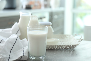 Glass of milk on grey table