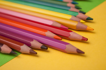 closeup of colouring pencils on color background