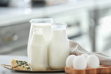 Different milk products with eggs on table