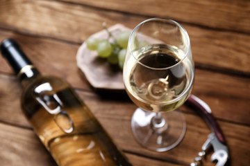 Glass of white wine on wooden table