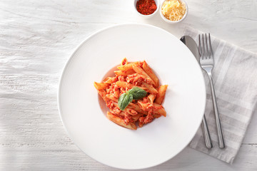 Tasty penne pasta with tomato sauce on plate