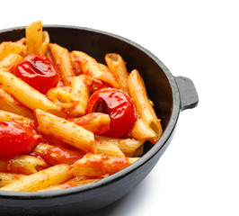 Frying pan with tasty penne pasta on white background