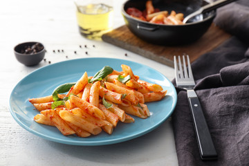 Tasty penne pasta with tomato sauce on plate