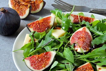 Bright healthy arugula fig salad. Fitness food. Colorful, healthy foods in flatlay style