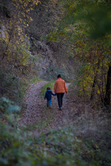 Obraz premium Woman and boy walking at the forest road