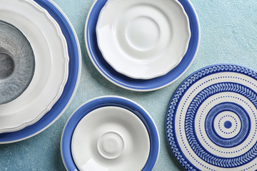 Set of clean tableware on color background, top view