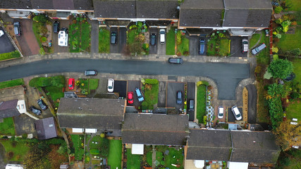 Aerial view over suburban homes and roads in the UK