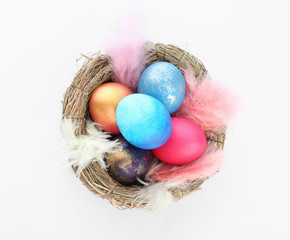 Nest with Easter eggs on white background