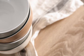Set of clean bowls on wooden table, closeup