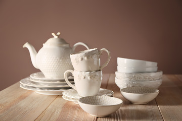 Set of clean dishware on wooden table