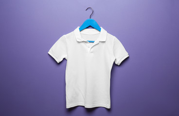 Child t-shirt with hanger on color background