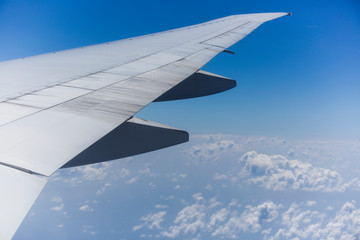 Right Wing of an Aircraft with Rear Engine and Blue Sky at Background