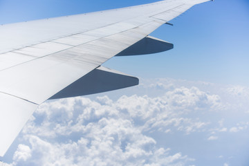 Fototapeta premium Right Wing of an Aircraft with Rear Engine and Blue Sky at Background