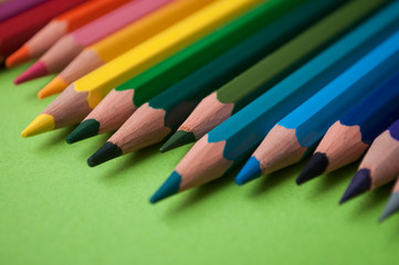 closeup of colouring pencils on green background