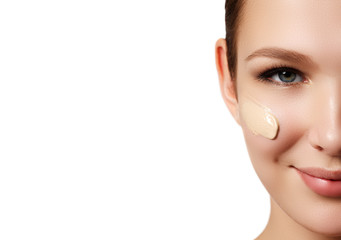 Fototapeta premium Beautiful girl applying some cream to her face for skin care. Youth and skin care concept. Woman beauty face portrait isolated on white with healthy skin. Portrait spa woman with perfect face