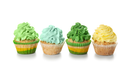Delicious colorful cupcakes on white background