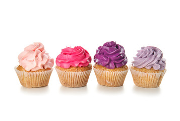Delicious colorful cupcakes on white background