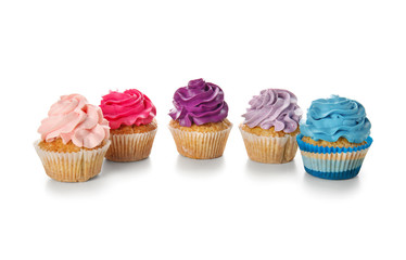 Delicious colorful cupcakes on white background