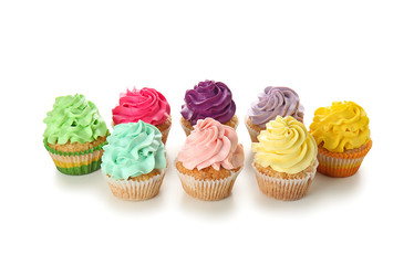 Delicious colorful cupcakes on white background