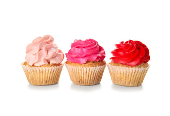 Delicious colorful cupcakes on white background
