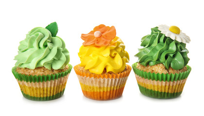 Delicious colorful cupcakes on white background