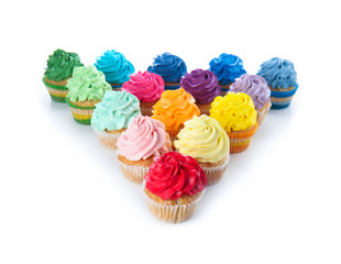 Delicious colorful cupcakes on white background