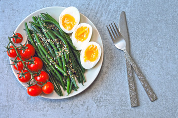 Colorful, healthy foods. flatlay. Buddha bowl with eggs, green beans and cherry tomatoes