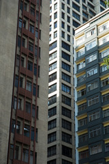 Composition of the facades of three modern residential and business buildings.