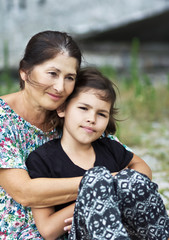 Happy grandmother and granddaughter in the sunny day.