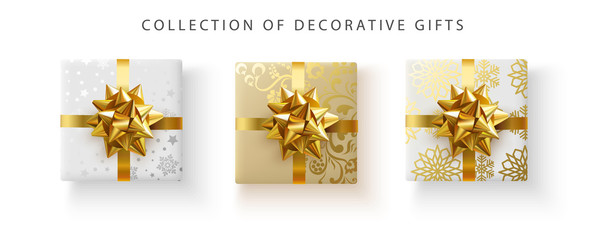 Set of decorative gifts with golden satin bow isolated on white.