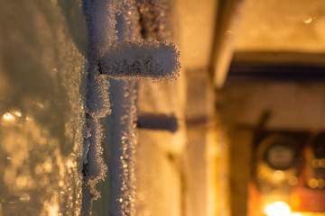 door handle and keyhole are covered with frost. severe frosts. door freezes. icy handle and lock covered with snowflakes. blurred background