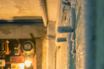 door handle and keyhole are covered with frost. severe frosts. door freezes. icy handle and lock covered with snowflakes. blurred background