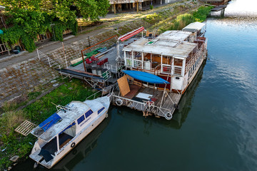 Naklejka premium Zrenjanin, Serbia - May 17, 2018: The Begej River passes through the town of Zrenjanin. Raft restaurant on the river.