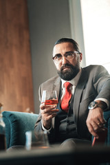 Bearded lawyer looking at his hand watch while running late