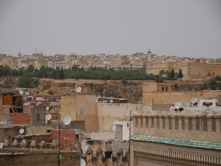 Panorama of the old town in Fez, Morocco, roofs of an with brown houses and satellite antennas in...