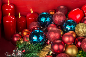 Christmas and New Year decoration balls  and candels on red background