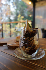 chocolate parfait with brownie and walnut serving in transparent glass