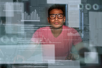 Young spectacled concentrated indian big data developer