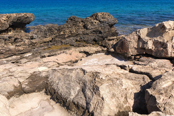 Fototapeta na wymiar Stony Mediterranean coast in the vicinity of Protaras, Cyprus. Summer Sunny day of August.
