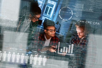 Young team of marketing department are looking over the data